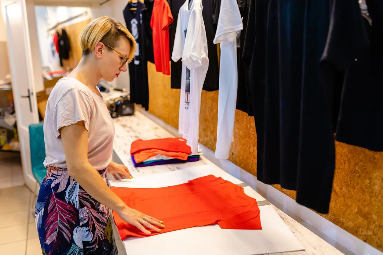 direct-to-garment-printing-services-woman-placing-tshirt-in-table